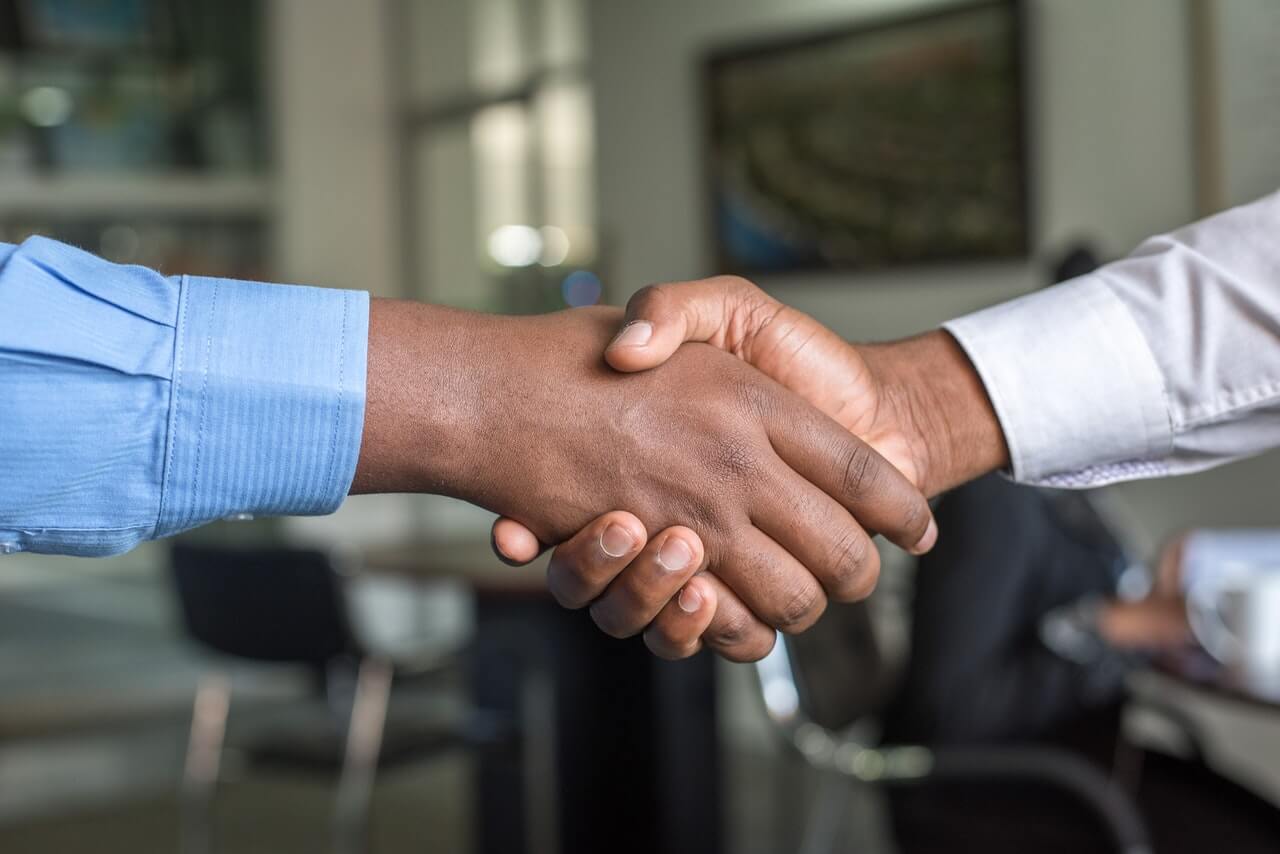 close up of two property management professionals shaking hands